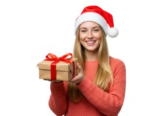 A happy young woman wearing a santa hat holds a christmas gift, isolated on a transparent background