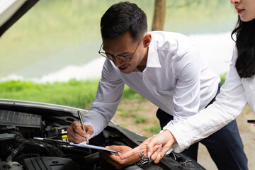 Insurance Agent. Professional assisting client with car maintenance outdoors.