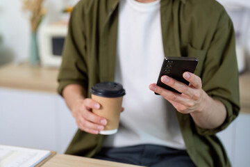 Working from Home. Checking Messages with Coffee in Hand