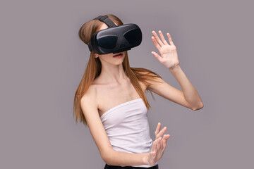 Caucasian female teen engaged with virtual reality headset and interactive experience.