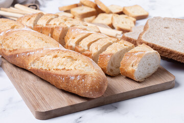 Assortment of Bread Products on white marble background
