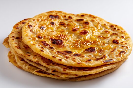Delicious puran poli flatbread with jaggery served on a clean white background showcasing traditional Indian cuisine