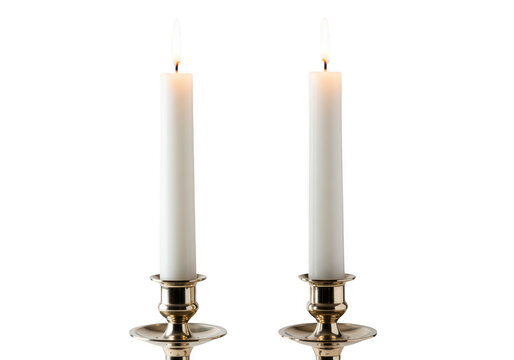 Two white candles burning brightly in ornate brass holders, isolated on white isolated on transparent background