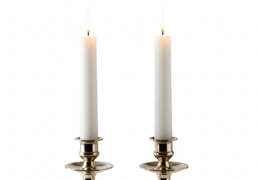 Two white candles burning brightly in ornate brass holders, isolated on white isolated on transparent background