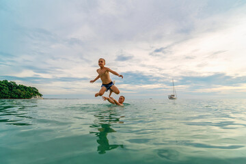 boy jumping into the sea