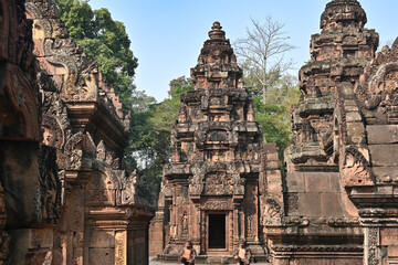 Naklejka premium Ancient temple complex with richly decorated stone towers and carvings, showcasing traditional Southeast Asian religious architecture.
