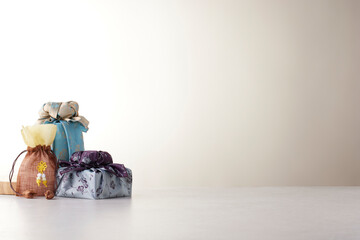 Elegant Korean table setting with traditional Korean bojagi gift wrapping for Chuseok, ceramic vase...