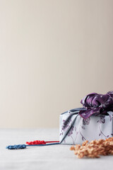 Elegant Korean table setting with traditional Korean bojagi gift wrapping for Chuseok, ceramic vase...