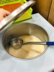 Traditional Korean rice wine (Makgeolli) served in a large bucket