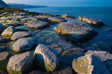 Rocky shoreline in under moonlight