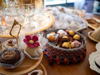 Elegant arrangement of traditional Arabic desserts, including pastries and sweets, prepared to...