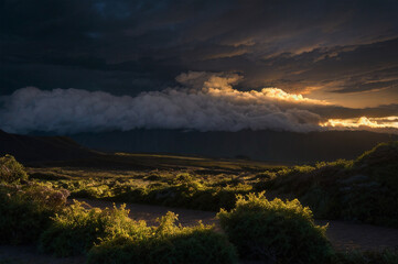 Twilight valley in under stormy clouds