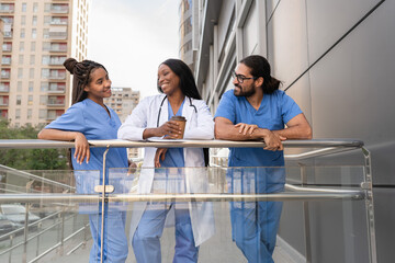 Multiracial diverse Doctors and nurses enjoying a coffee break outside the hospital