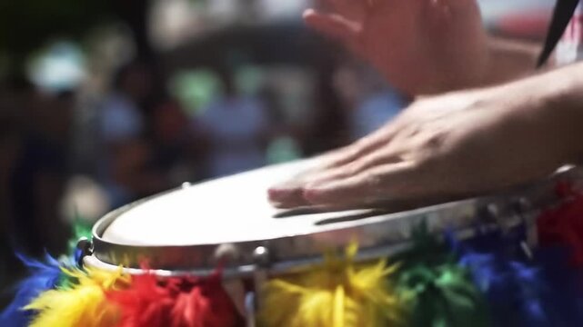 Hands playing a drum at a festival