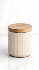 Cream ceramic canister with ribbed texture and light wood lid; minimalist home decor.