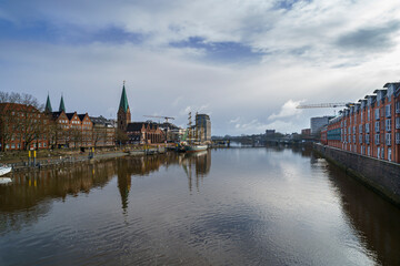 Obraz premium Bremen’s skyline shines after the storm, as seen from the Weser Bridge, Germany