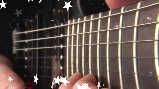 Opening focusing on steel guitar, guitarist practicing picking low E string sliding, stars drifting