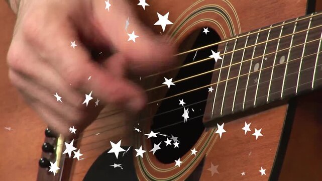 Hand entering frame causing strum, strumming along strings for rhythmic beat with flickering stars