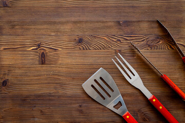 Set with barbecue utensils and equipment with red picnic napkin. Stainless steel tools. Top view