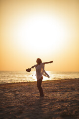 Fototapeta premium Woman Enjoying Freedom on Beach with Ukulele at Sunset 