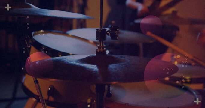 Dot patterns falling triggers drummer striking cymbals and bassist plucking bass for pulsing groove