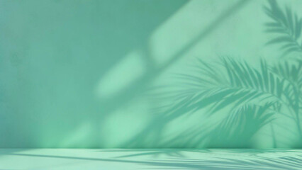 ミントグリーンの壁にヤシの葉の影が映える抽象的な背景。
