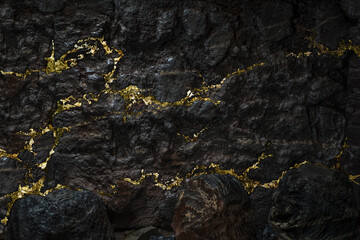 A gold vein, small pieces of gold nuggets within a rock, accumulation of gold in rocks, formed in cracks, faults, or fissures. Close up view
