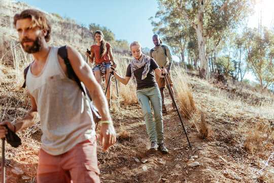 Young and diverse group of friends and hikers hiking together in the mountains of south africa - Powered by Adobe