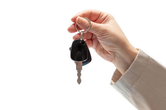 Hand holding car keys on isolated background. Concept of selling or renting a car
