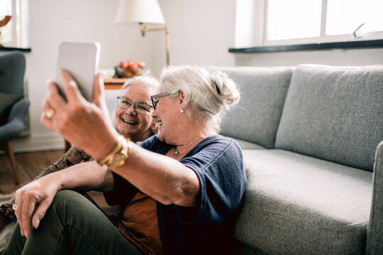 Senior women taking a happy selfie together at home - Powered by Adobe