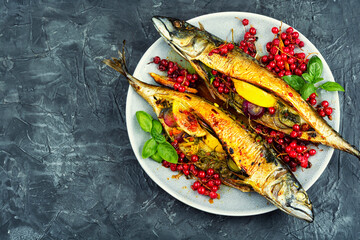 Fried or baked mackerel fish with berries.