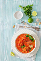 fish cakes in tomato vegetable coconut milk sauce