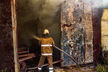 Portrait of firefighter extinguishing fire in action