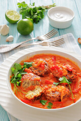 fish cakes in tomato vegetable coconut milk sauce