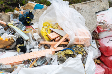 A large pile of trash featuring a plastic bag stuffed full of foam
