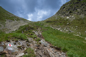 Mountain hiking trail in the Fagaras Mountains, Romania. Rocky alpine path in the Southern Carpathians.