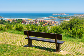 Bench overlooking the north coast of Spain and the town of Suances, Cantabria.