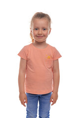 Portrait of a cheerful young girl in a casual orange t-shirt and jeans, standing and smiling...