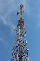 Cell phone tower with an antenna for mobile telecommunication and wireless network technology in the blue sky
