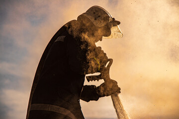 Portrait of firefighter extinguishing fire in action