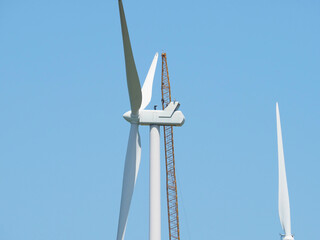 Wind turbine under maintenance with crane