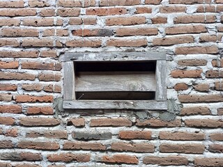 Rustic Brick Wall with Old Wooden Window Frame