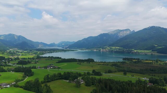 Aerial drone footage of Wolfgangsee Lake bathed in summer sunshine