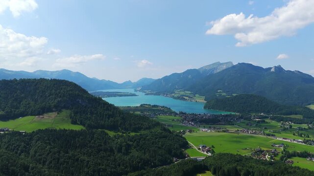 Drone footage showcasing Strobl, Lake Wolfgangsee, and the Salzburg Alps under midday sun