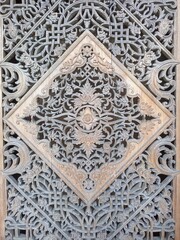Traditional Indonesian Wood Carving with Intricate Floral Motifs
