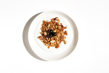 Healthy Greek Yogurt Served for Breakfast with Granola and Black Currants. Simple Delicious Breakfast.	