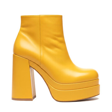 Retro fashioned bright yellow leather chunky platform boot with a thick heel and rounded toe isolated on white background, women footwear