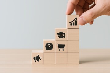Hand stacking wooden blocks with icons representing growth education shopping and marketing.