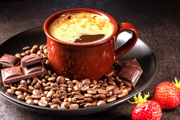 Delicious coffee composition with strawberries and chocolate on rustic wooden surface