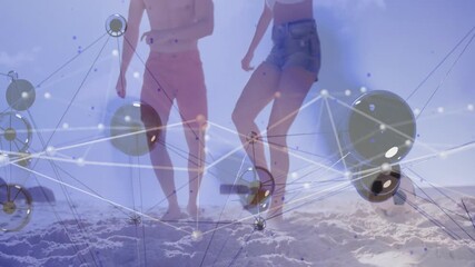Two players nudging soccer ball forward on beach while network overlay pulsing for sports tech demo - Powered by Adobe